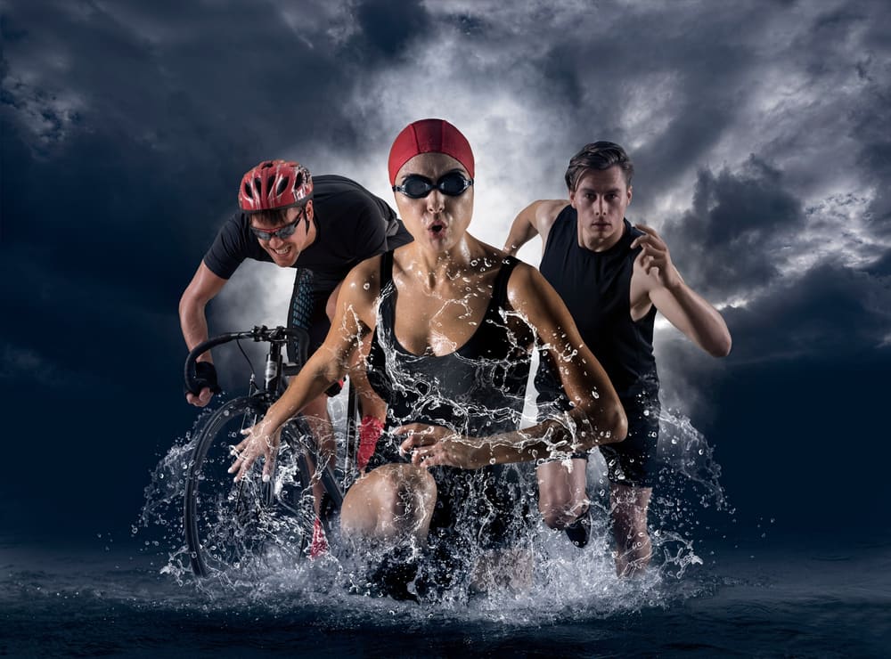 Athletes swimming, cycling and running